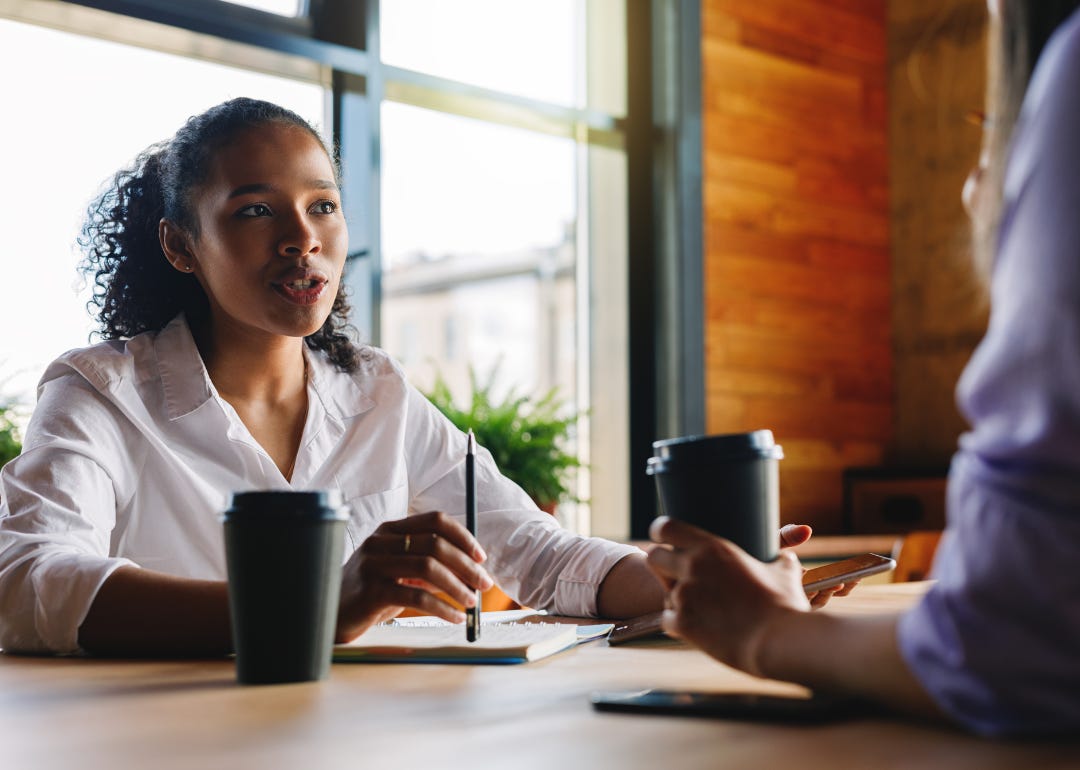 Two people at a coffee shop having a meeting.